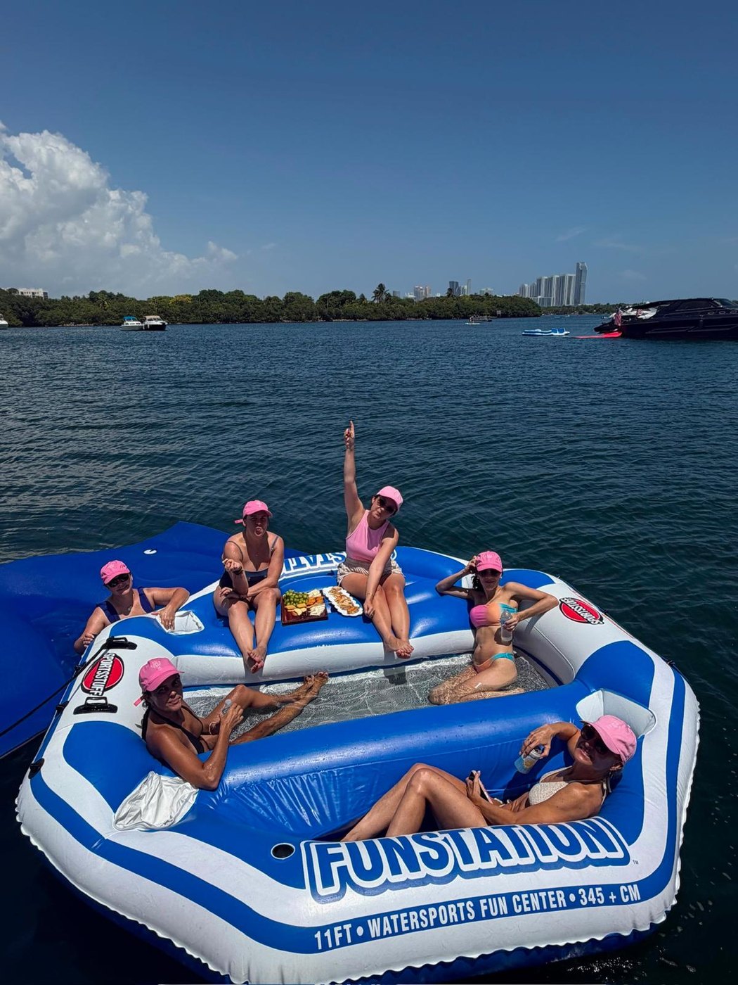 Friends on the float with a charcuterie board