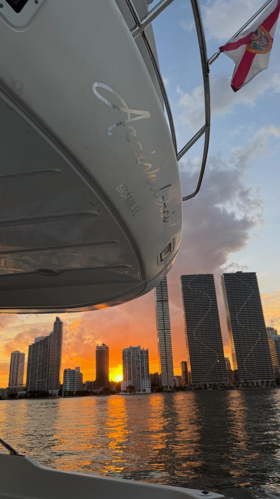 The Arrivederci hull and the Miami skyline at sunset