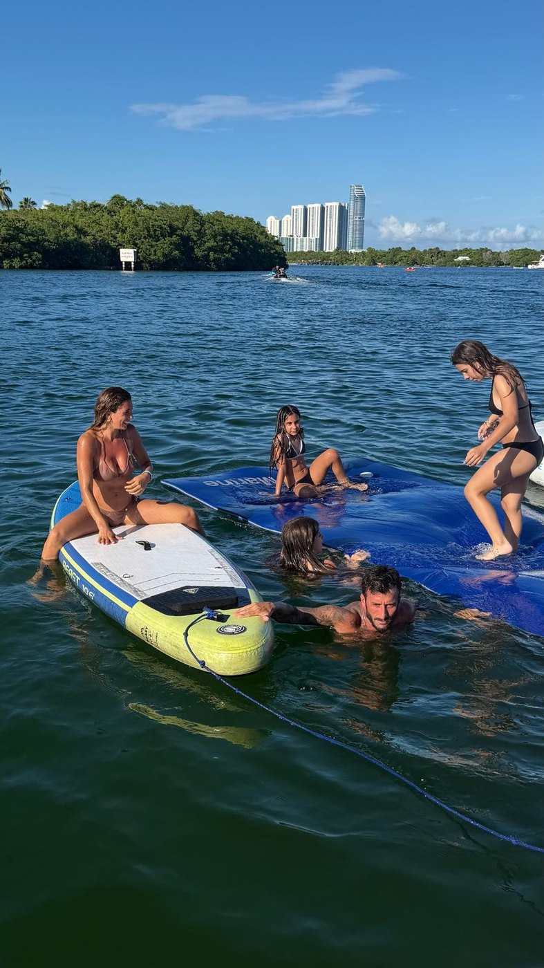 Family at the sandbar with the paddleboard and float mat