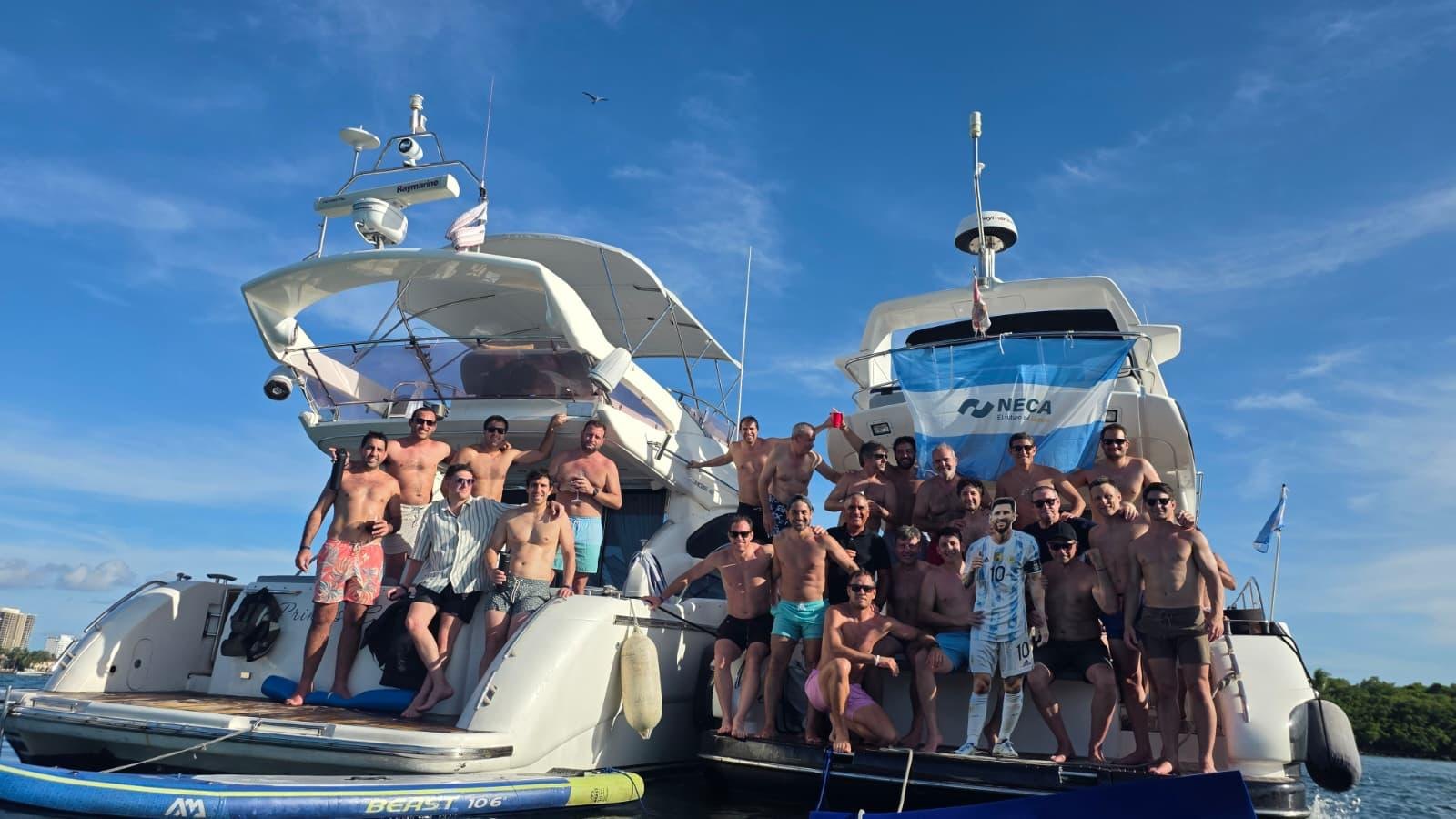 Big group celebrating on two yachts rafted together
